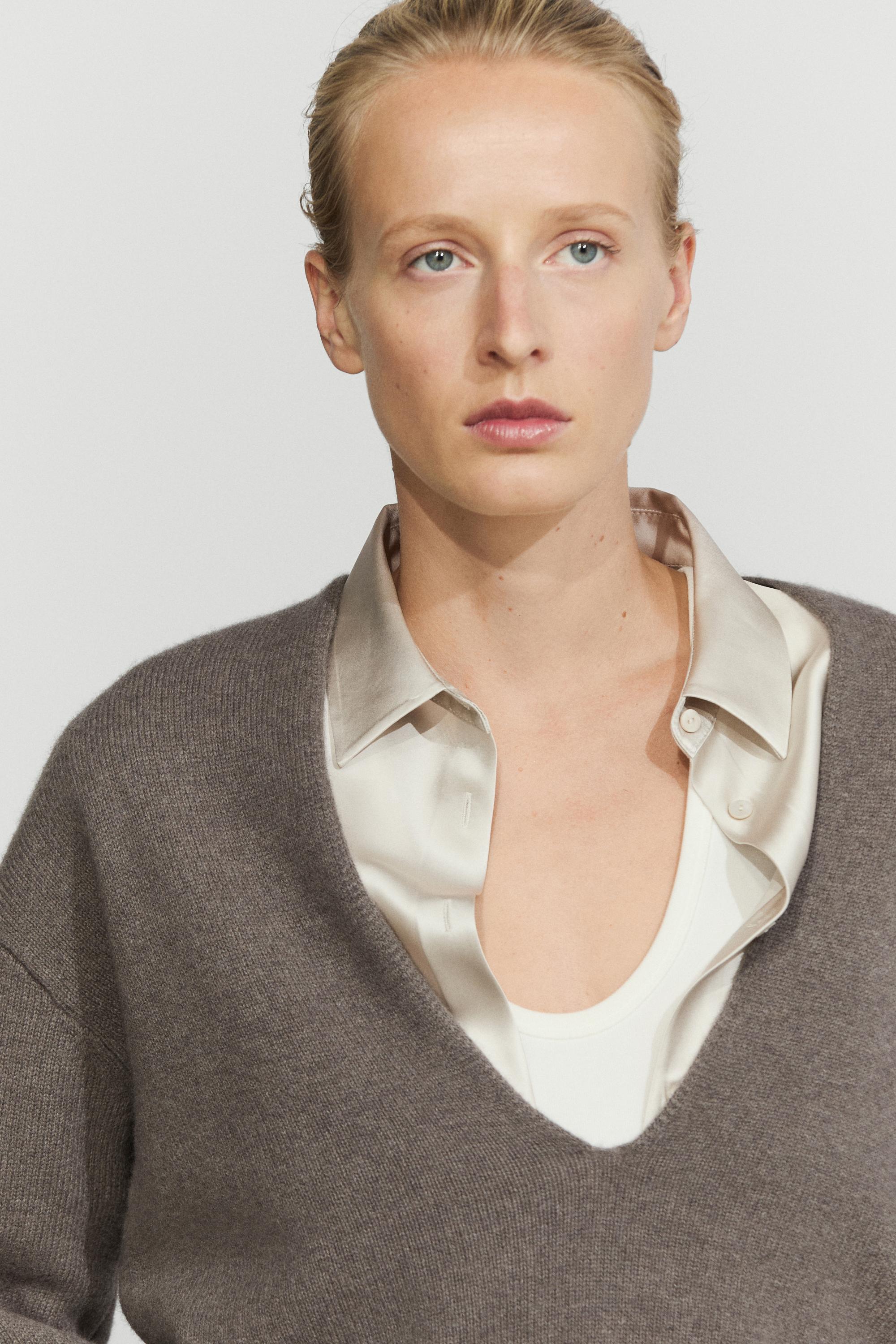 Long-line knit sweater with neckline detail